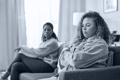 daughter on sofa angry with mother