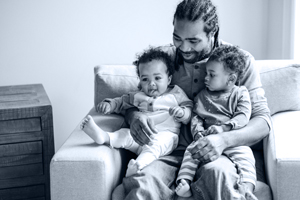 father sitting with his young sons